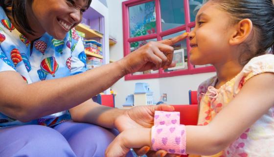 Child and nurse in a school location 