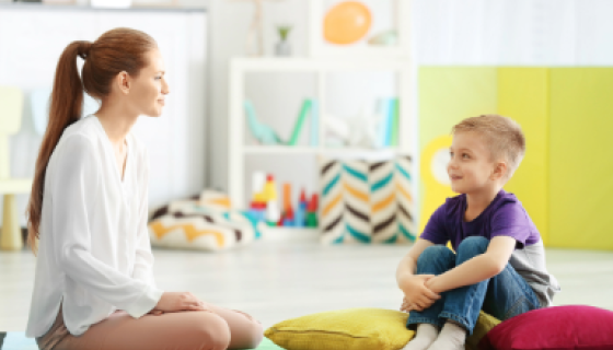 Educator sitting on the floor with a child