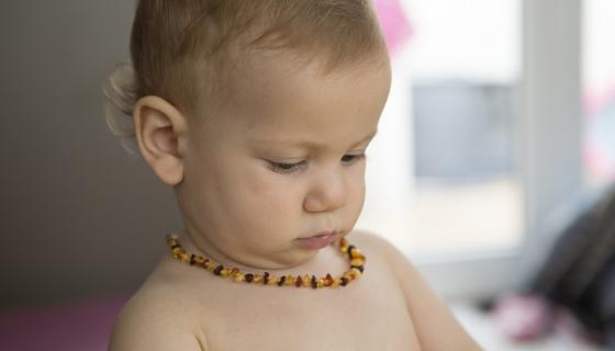 Baby wearing an amber necklace
