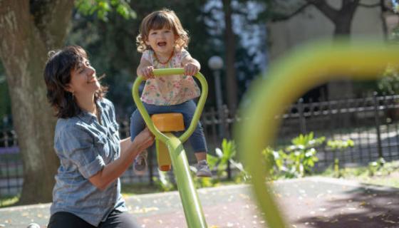 Adult with Child On SeeSaw